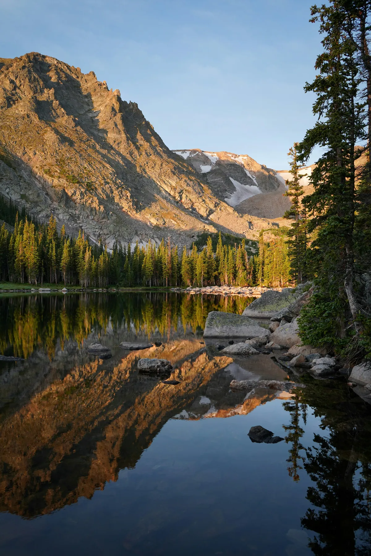 A lake surrounded by mountains and trees in Rocky Mountain National Park, Colorado